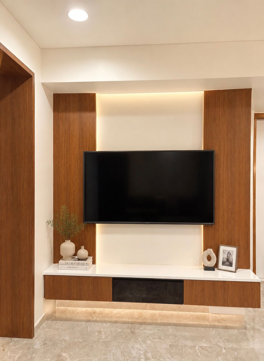 Media wall with built-in television console at Begwani's Residence